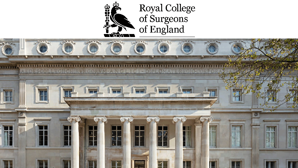 The image shows the front of a large, historic building with neoclassical architecture. The façade features columns and numerous windows.