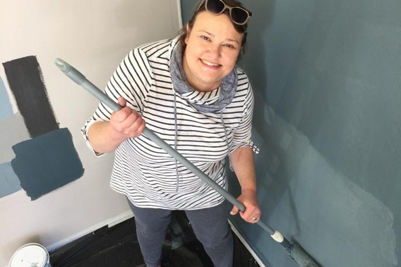 home-hemodialysis-francie-woman-sunglasses-in-hair-holding-a-broom