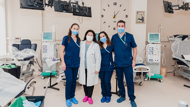 A group of nurses standing together in a hospital room, showcasing teamwork and professionalism in a healthcare setting.
