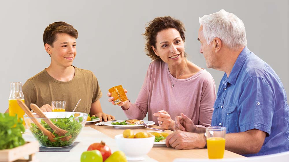 Three people sitting at the breakfast table
